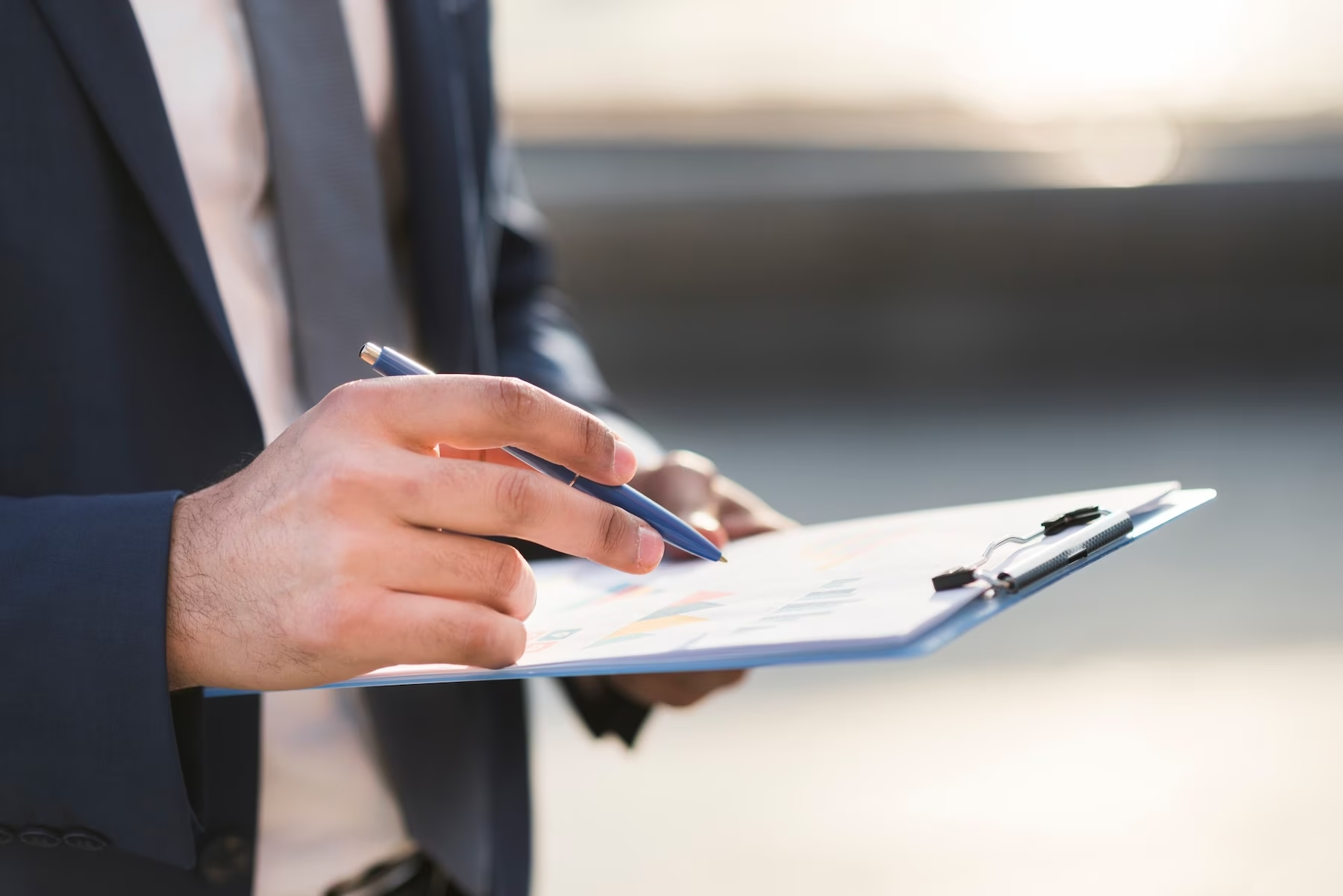 close-up-business-man-checking-clipboard_23-2148479569