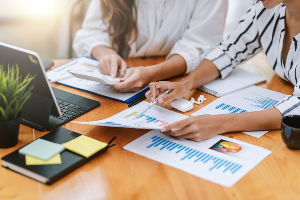 Close-up of business people analyzing chart and graph showing changes on the market.