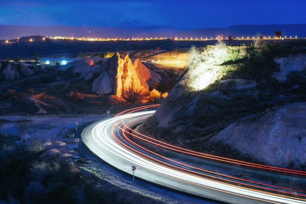 Night road in the mountains, the lights from the headlights